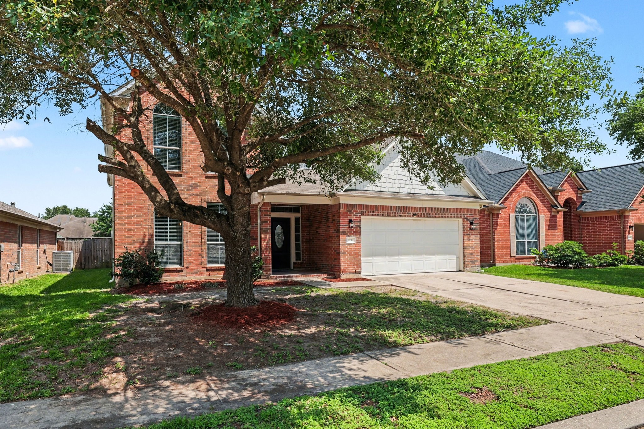 22310 Lamaster Lane Spring, TX 77373 - Photo 3 of 48 Charming brick home with a spacious front yard and a large tree providing shade. Features a two-car garage and a welcoming entrance. Ideal for families seeking a comfortable and inviting neighborhood setting.