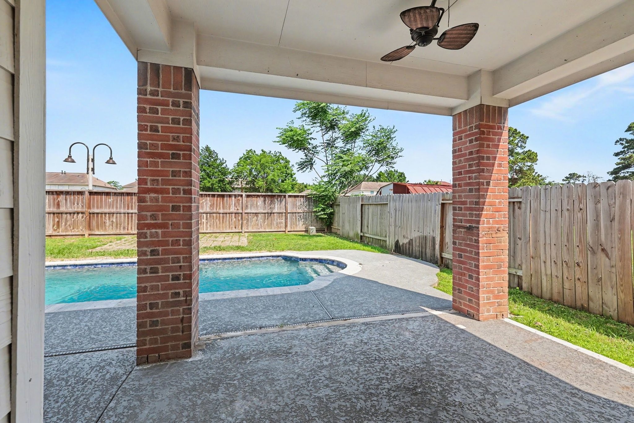 22310 Lamaster Lane Spring, TX 77373 - Photo 44 of 48 Covered patio with cool deck that leads to the pool that was installed in 2020. The pool comes with a cover.