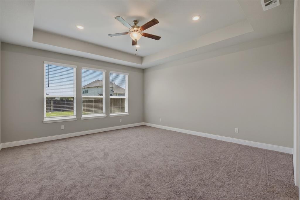 16812 Bitterroot Road Justin, TX 76247 - Photo 20 of 27 an empty room with windows and ceiling fan