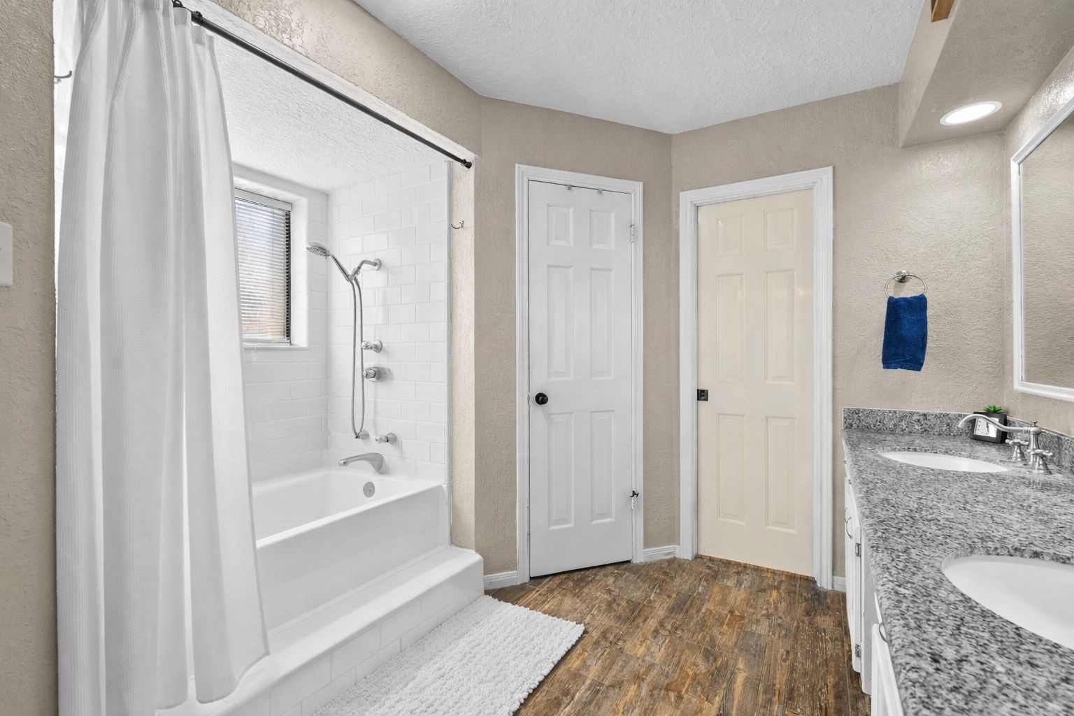 41 Windsor Drive Conroe, TX 77304 - Photo 24 of 39 Primary bathroom tub/shower area featuring a freshly refinished white soaking tub with classic subway tile surround, brushed-nickel fixtures, and a window that brings in natural light.