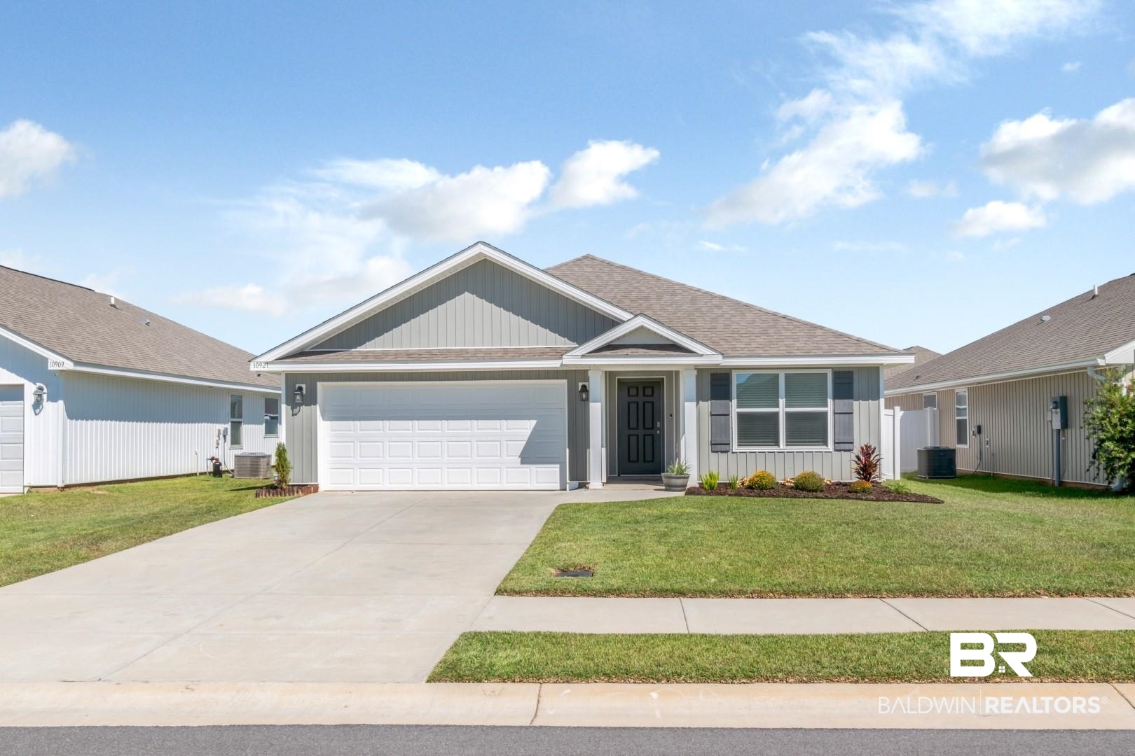 10921 Northern Dancer Court Daphne, AL 36526 - Photo 1 of 32 View of front of home featuring central air condition unit, a front lawn, and a garage