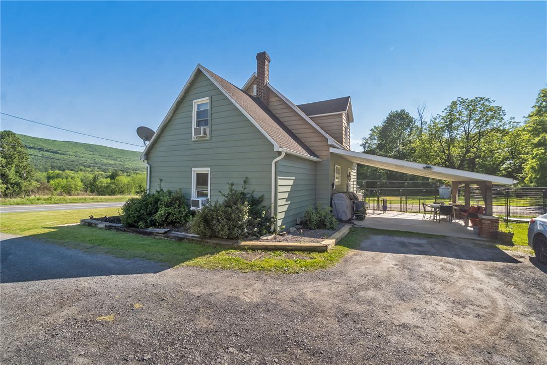 331 East Lizard Creek Road Lehighton, PA 18235 - Photo 5 of 37 A charming sage-hued residence with an expansive covered patio, ideal for outdoor gatherings.