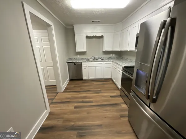 a kitchen with a refrigerator a sink and dishwasher