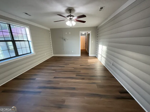 wooden floor in an empty room with a window
