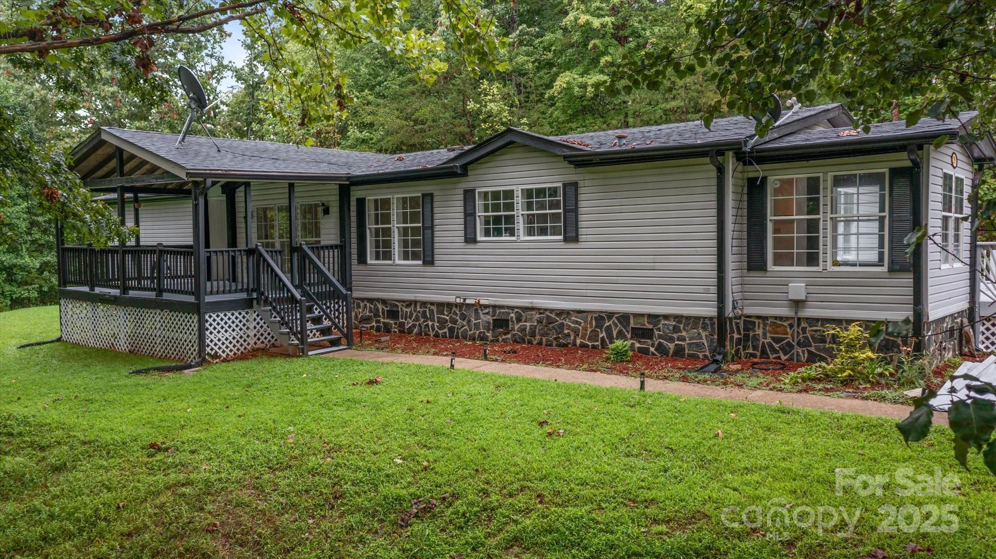a front view of house with yard and outdoor seating