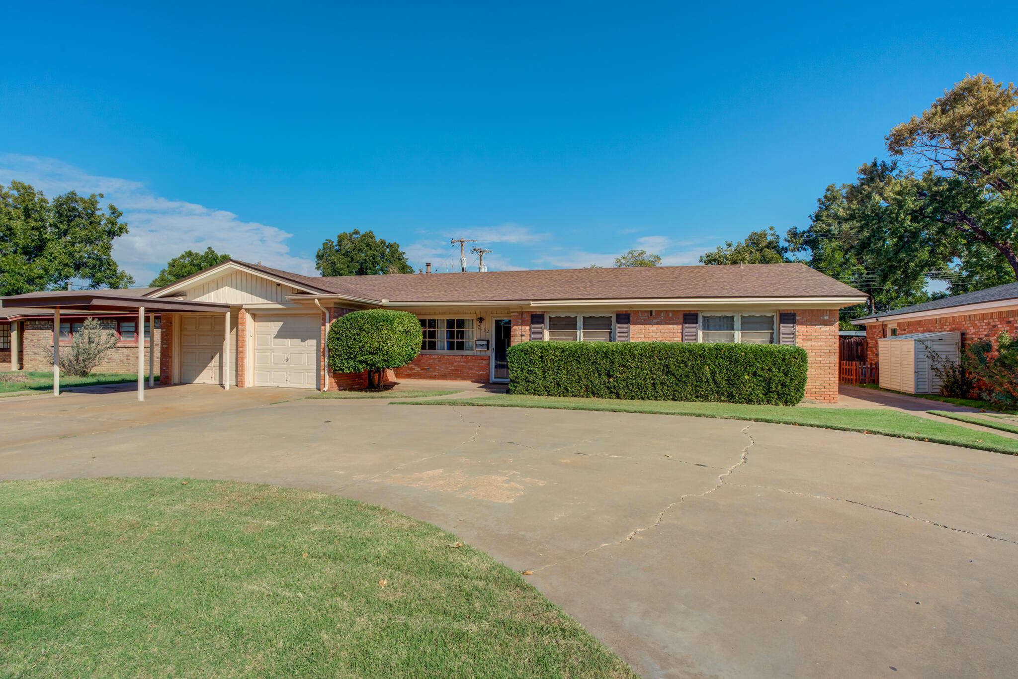 2132 69th Street Lubbock, TX 79412 - Photo 1 of 38 a front view of a house with a yard and potted plants