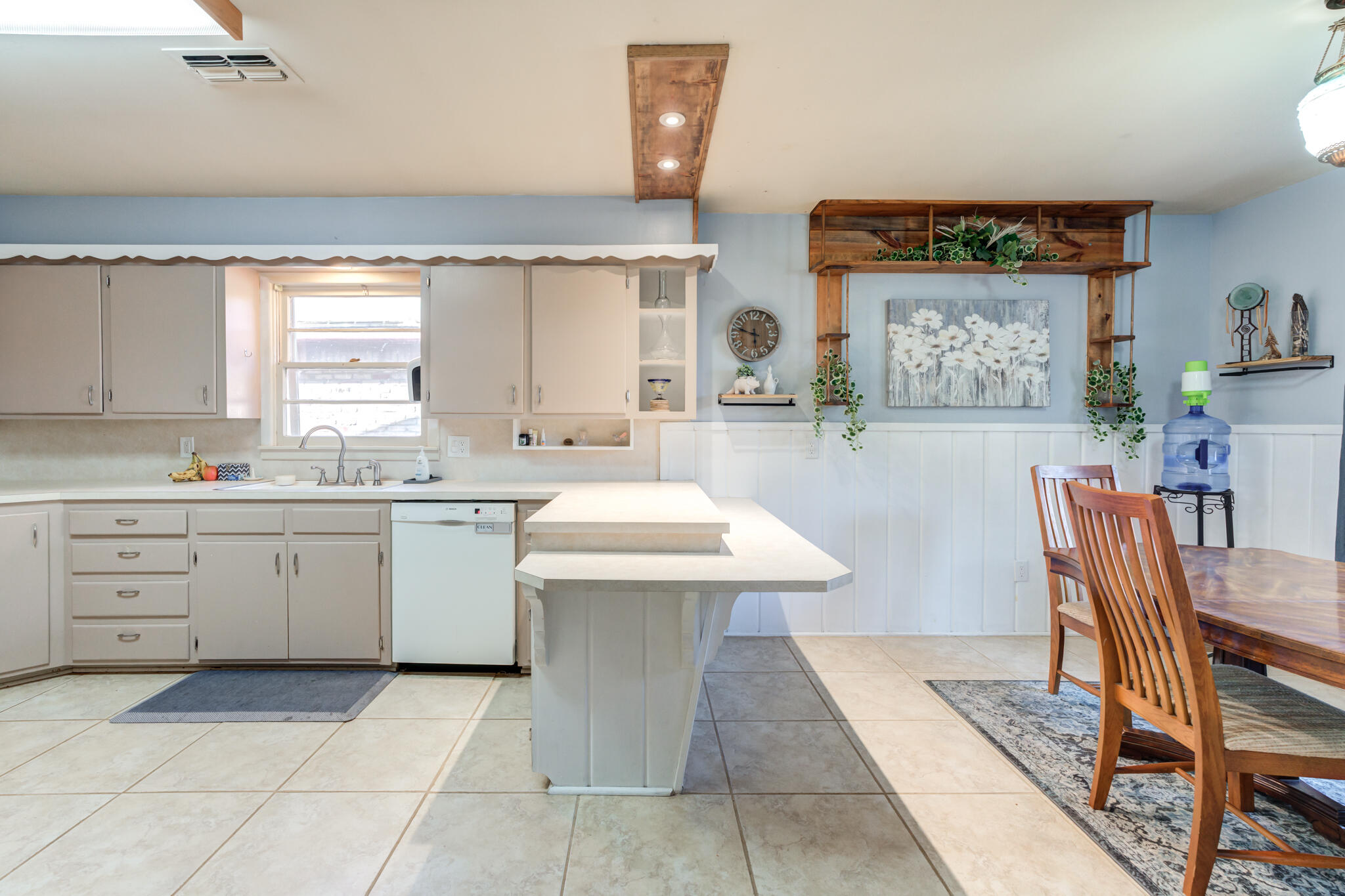 2132 69th Street Lubbock, TX 79412 - Photo 13 of 38 a kitchen with a sink a table and chairs