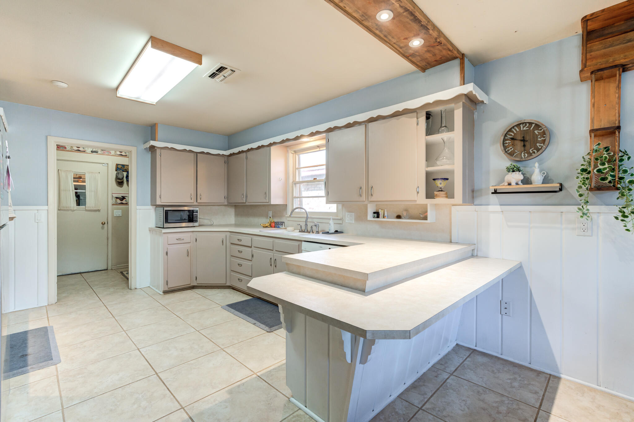 2132 69th Street Lubbock, TX 79412 - Photo 14 of 38 a kitchen with a sink window and cabinets