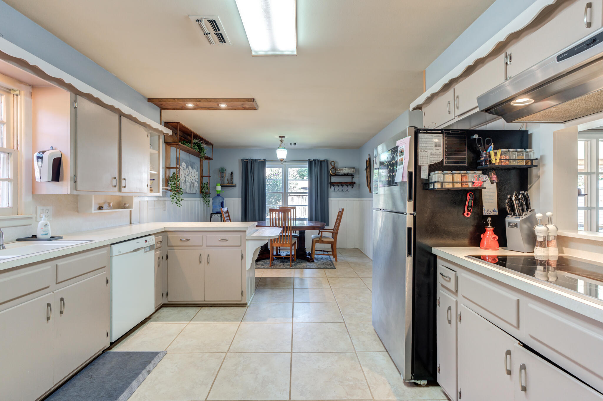 2132 69th Street Lubbock, TX 79412 - Photo 16 of 38 a kitchen with a sink and cabinets