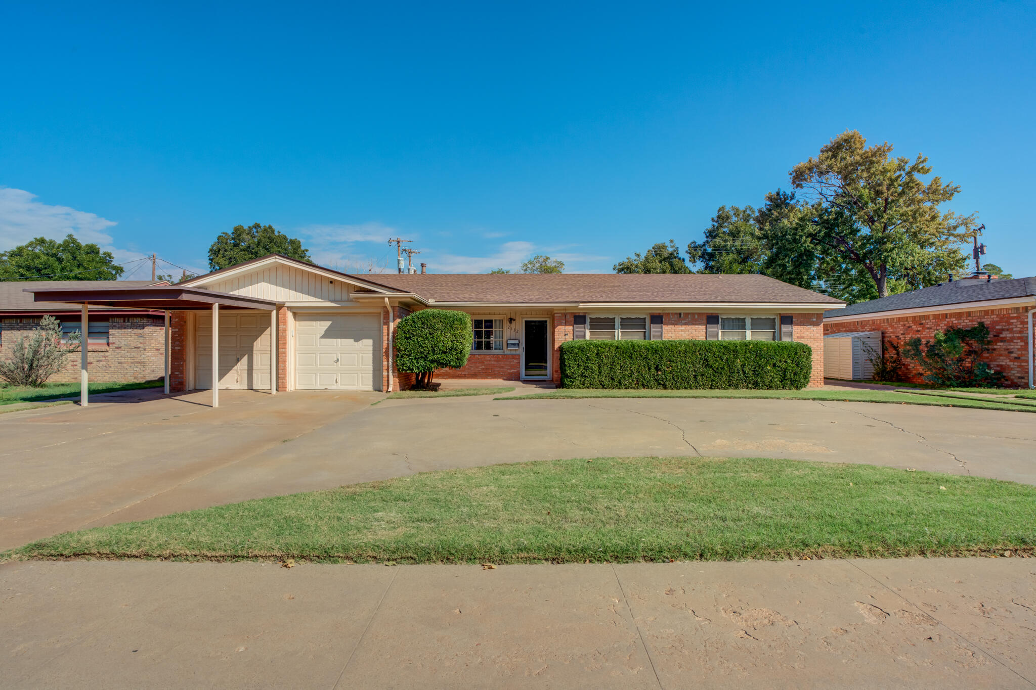 2132 69th Street Lubbock, TX 79412 - Photo 2 of 38 a front view of a house with a yard and garage