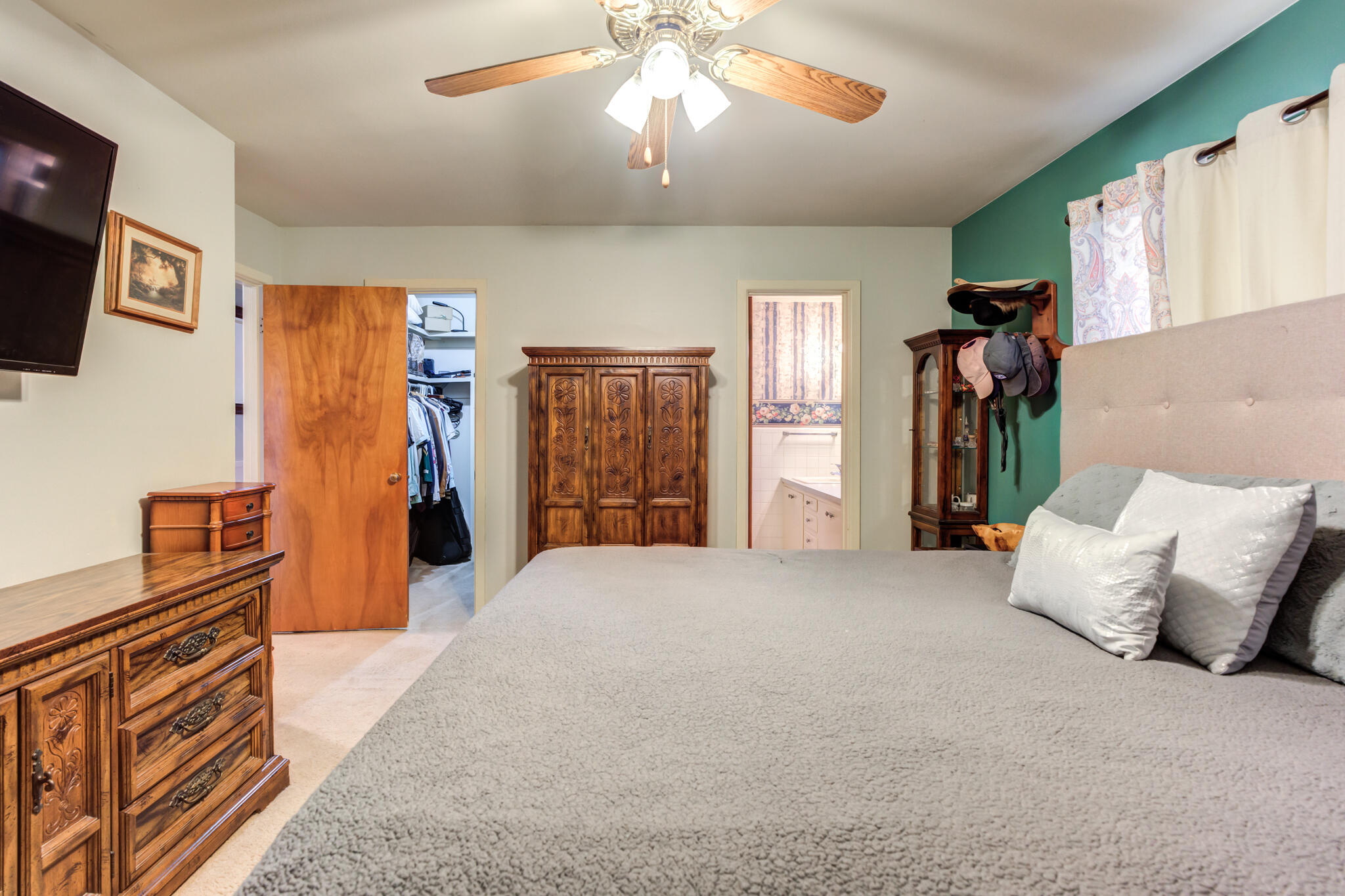 2132 69th Street Lubbock, TX 79412 - Photo 24 of 38 a spacious bedroom with a bed and a flat screen tv