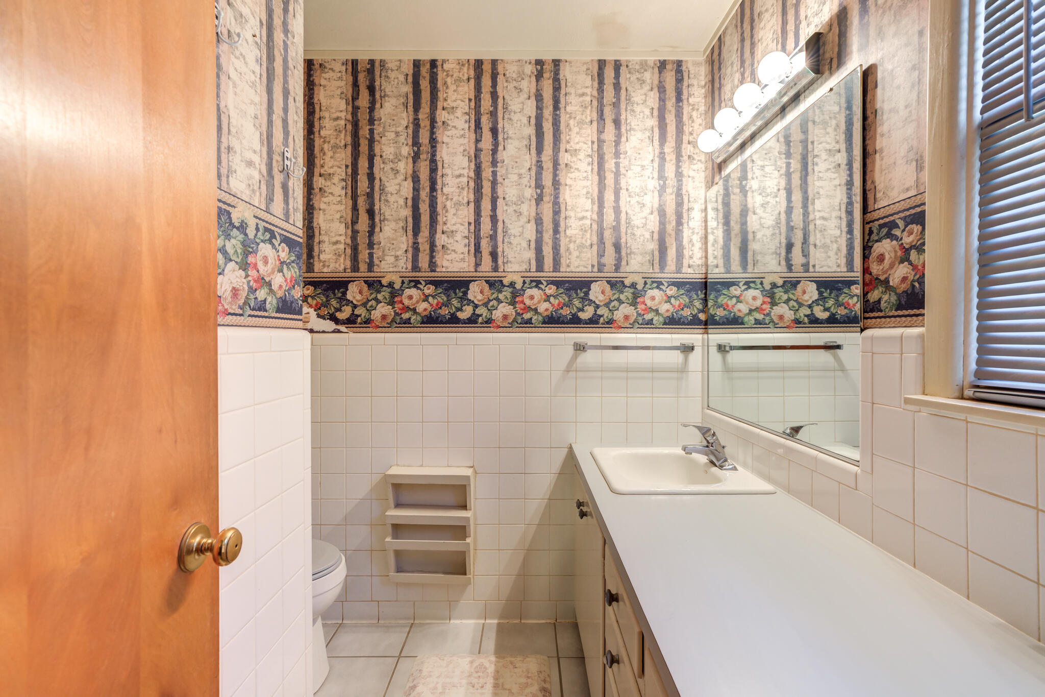 2132 69th Street Lubbock, TX 79412 - Photo 25 of 38 a bathroom with a sink and a mirror