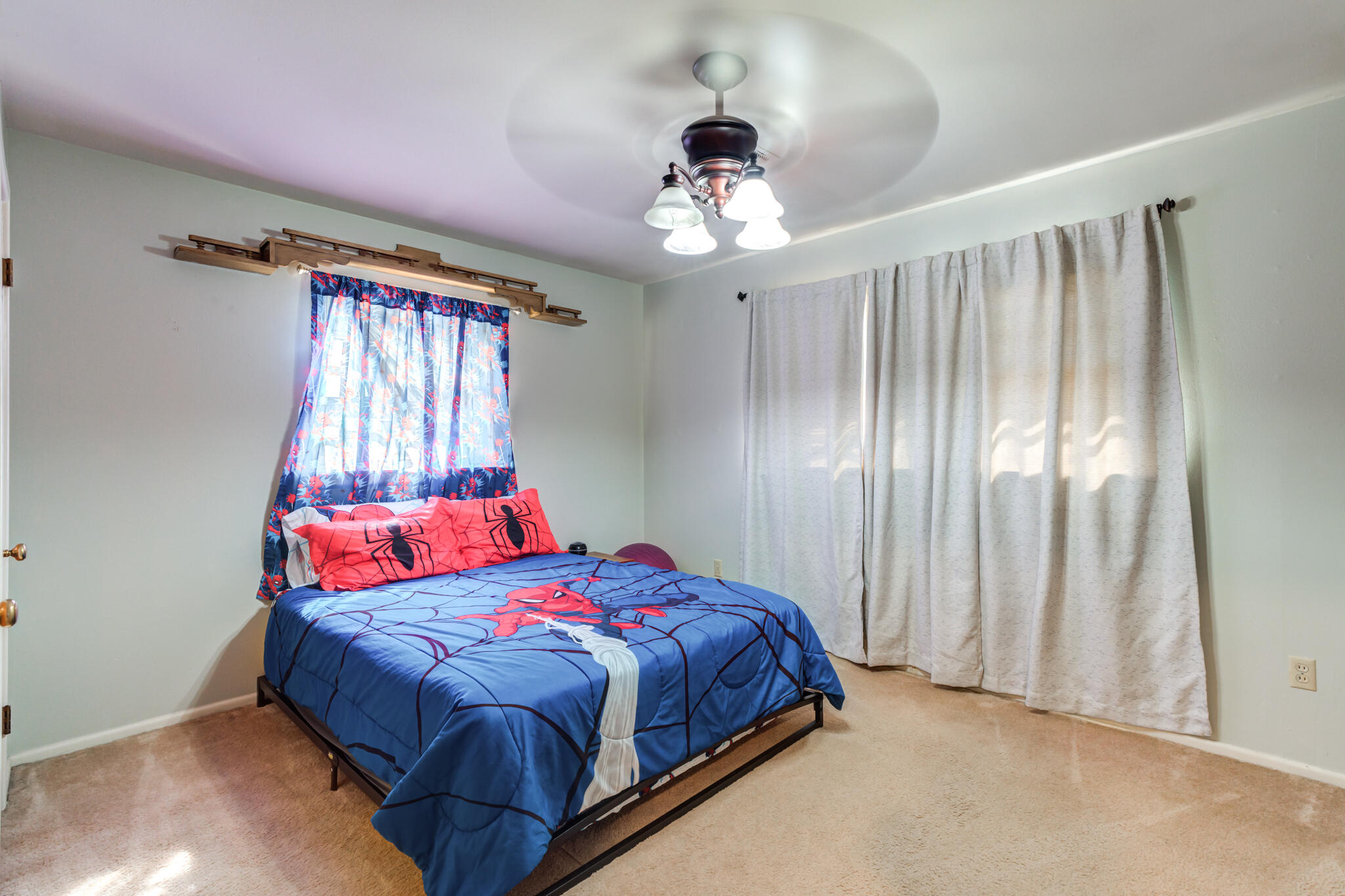 2132 69th Street Lubbock, TX 79412 - Photo 30 of 38 a bedroom with a bed and a chandelier