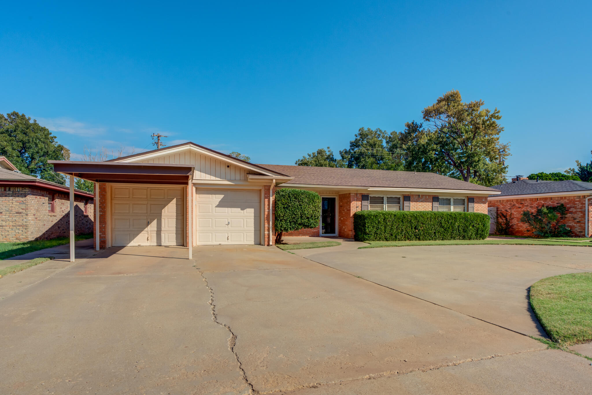 2132 69th Street Lubbock, TX 79412 - Photo 3 of 38 a front view of a house with a yard and garage