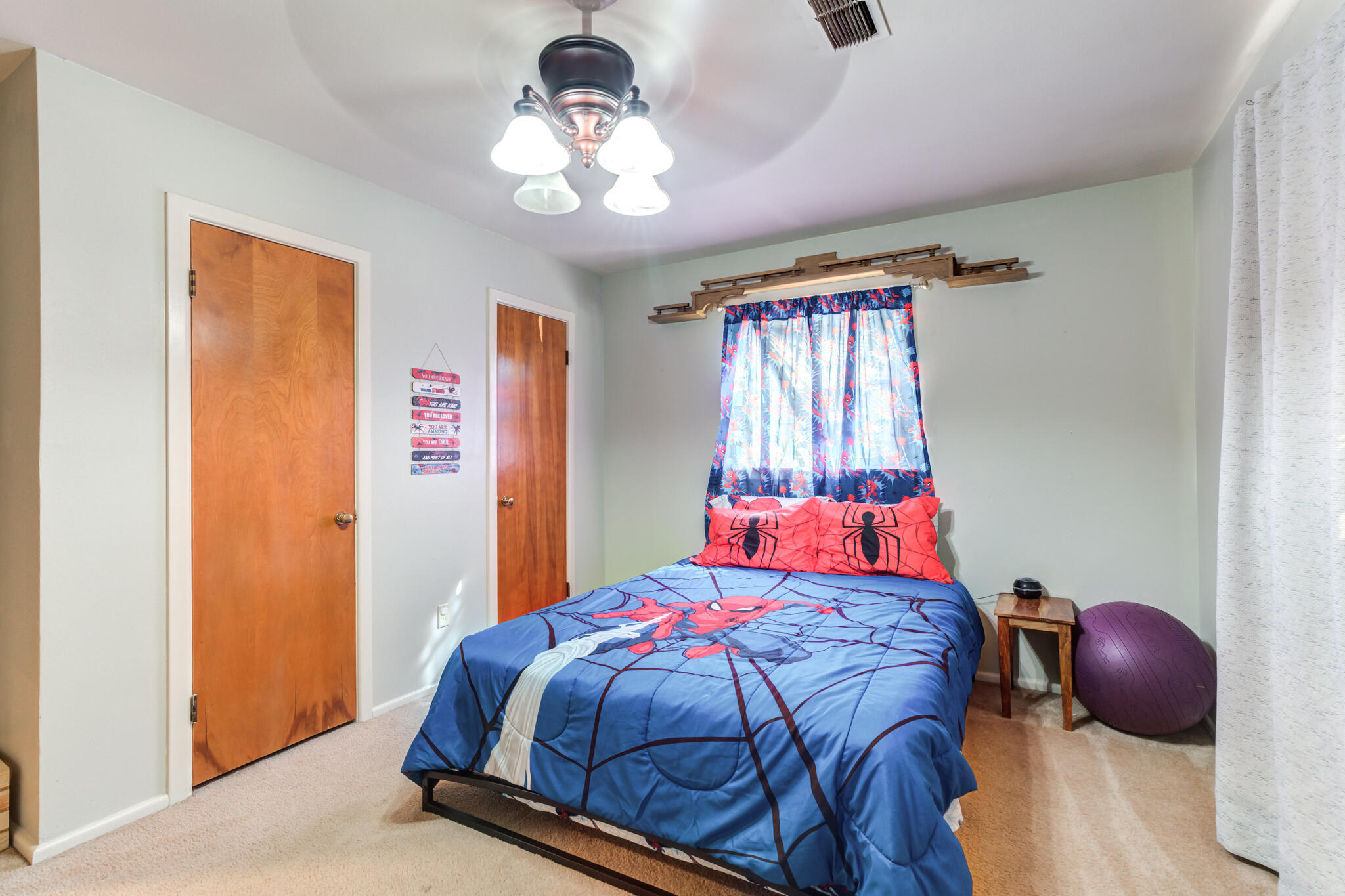 2132 69th Street Lubbock, TX 79412 - Photo 31 of 38 a bedroom with a bed and a chandelier