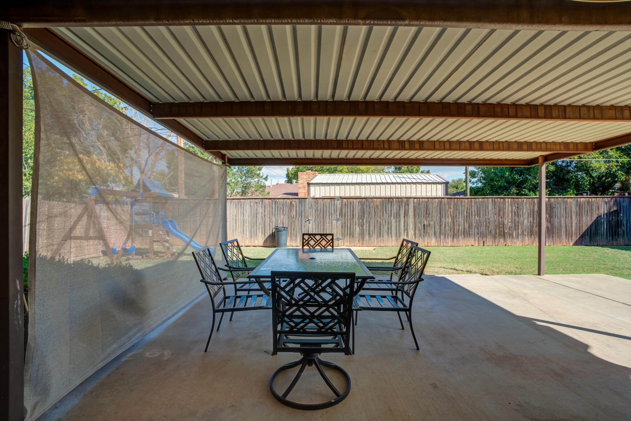 2132 69th Street Lubbock, TX 79412 - Photo 35 of 38 a view of patio with table and chairs and wooden floor
