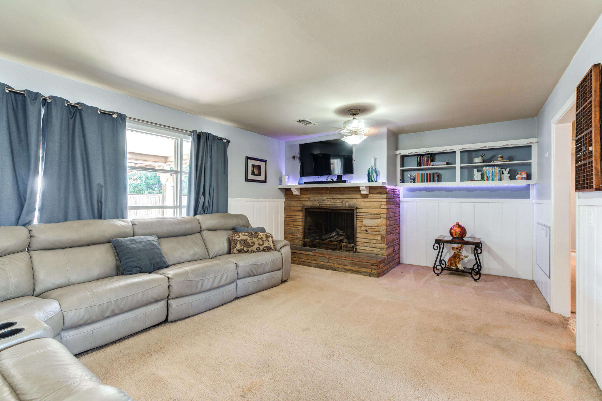 2132 69th Street Lubbock, TX 79412 - Photo 7 of 38 a living room with furniture and a fireplace