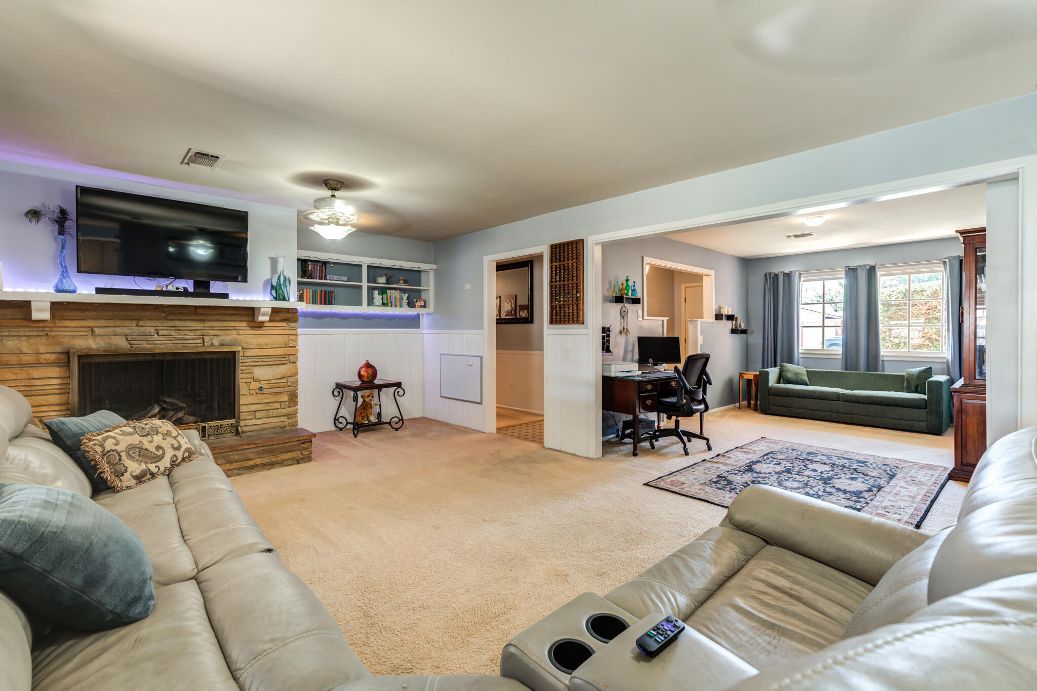 2132 69th Street Lubbock, TX 79412 - Photo 8 of 38 a living room with furniture and a fireplace