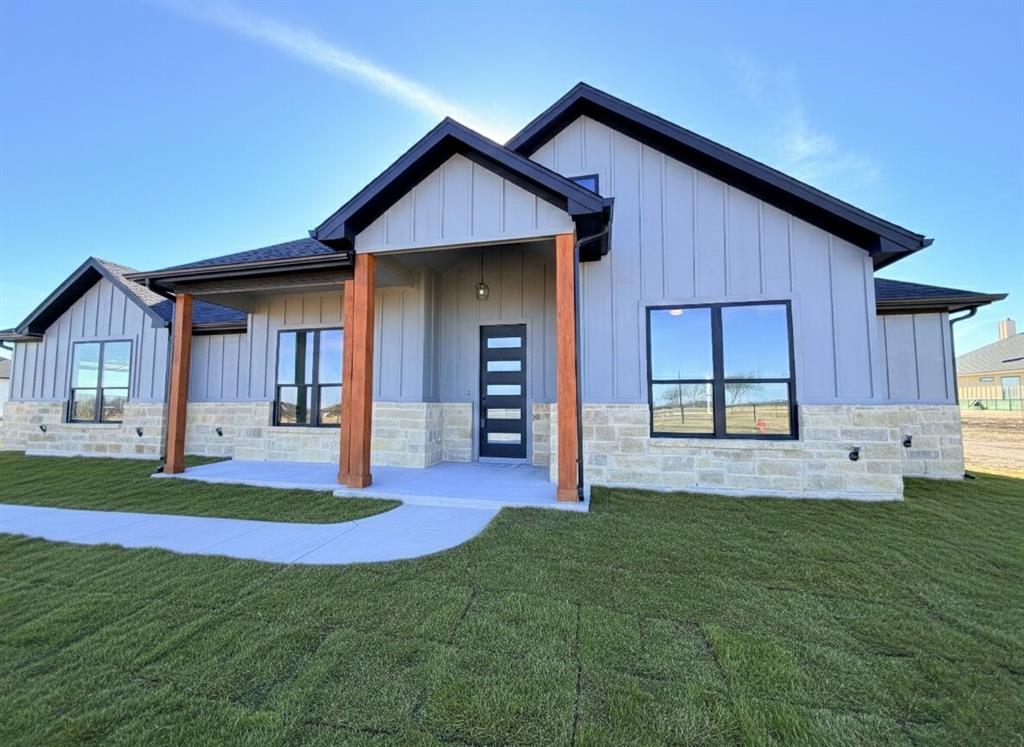 a front view of a house with a yard and porch
