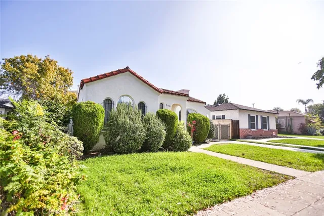 a view of a garden with a house