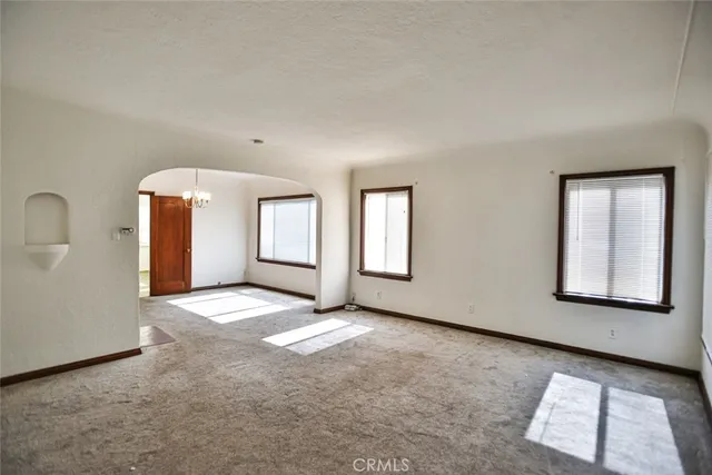 a view of an empty room and closet area