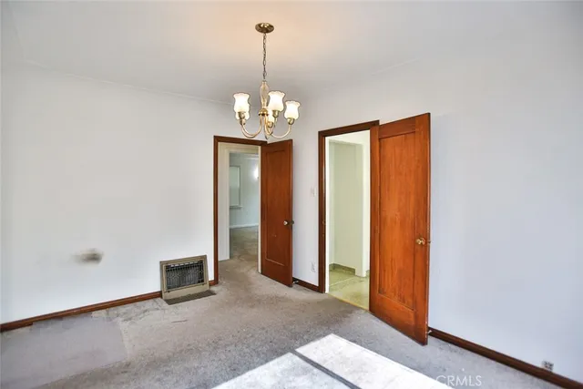 a kitchen that has a lot of cabinets in it with a large window