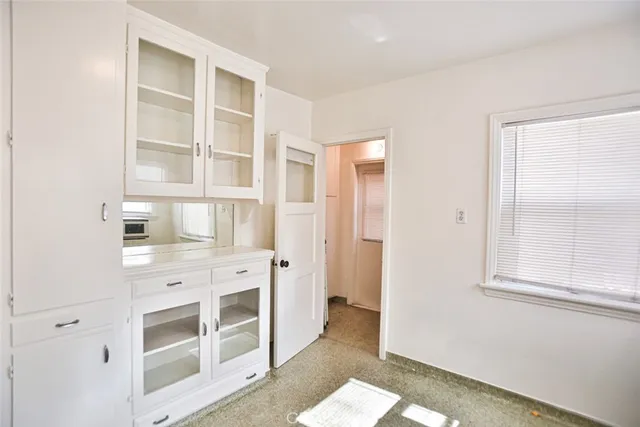 a bathroom with a granite countertop toilet and a shower