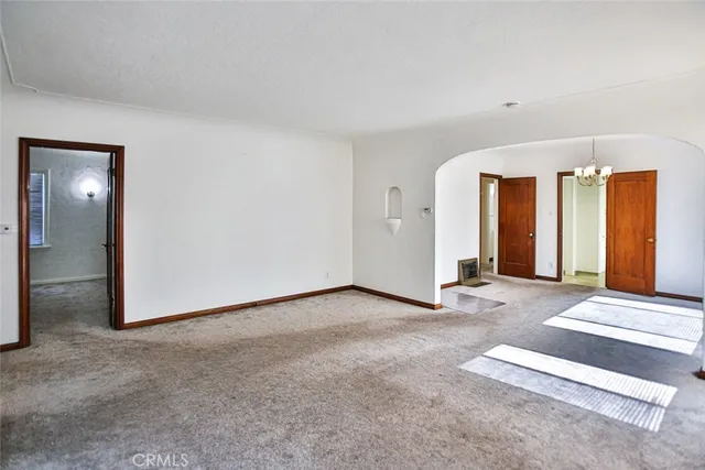 a view of an empty room with closet and closet