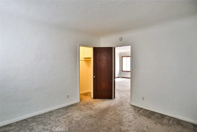 a view of a chandelier in big room with windows and chandelier