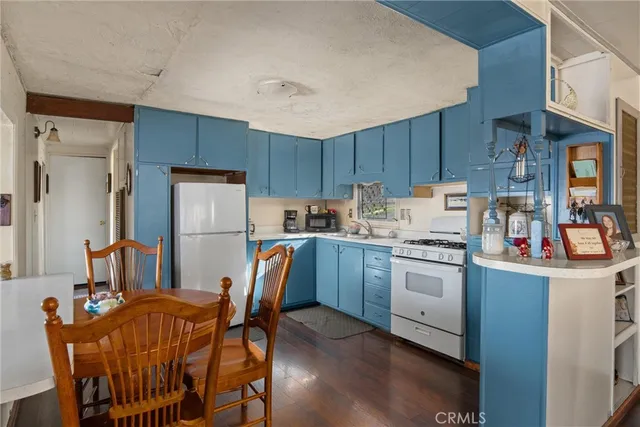 a kitchen with stainless steel appliances a stove a sink dishwasher and a refrigerator