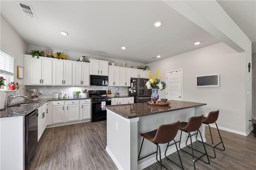 266 Shoals Bridge Road Acworth, GA 30102 - Photo 14 of 43 a kitchen with granite countertop cabinets stainless steel appliances with chair and table in it