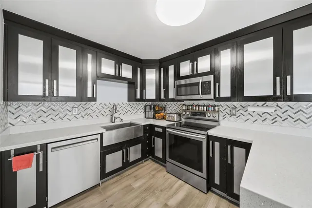 a kitchen with stainless steel appliances granite countertop a stove and a sink