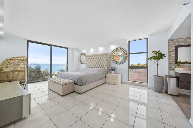 a spacious bedroom with a large bed and a table