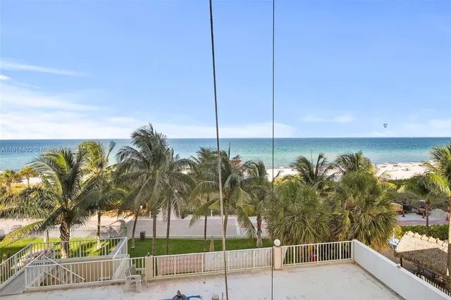 a view of a palm tree from a balcony