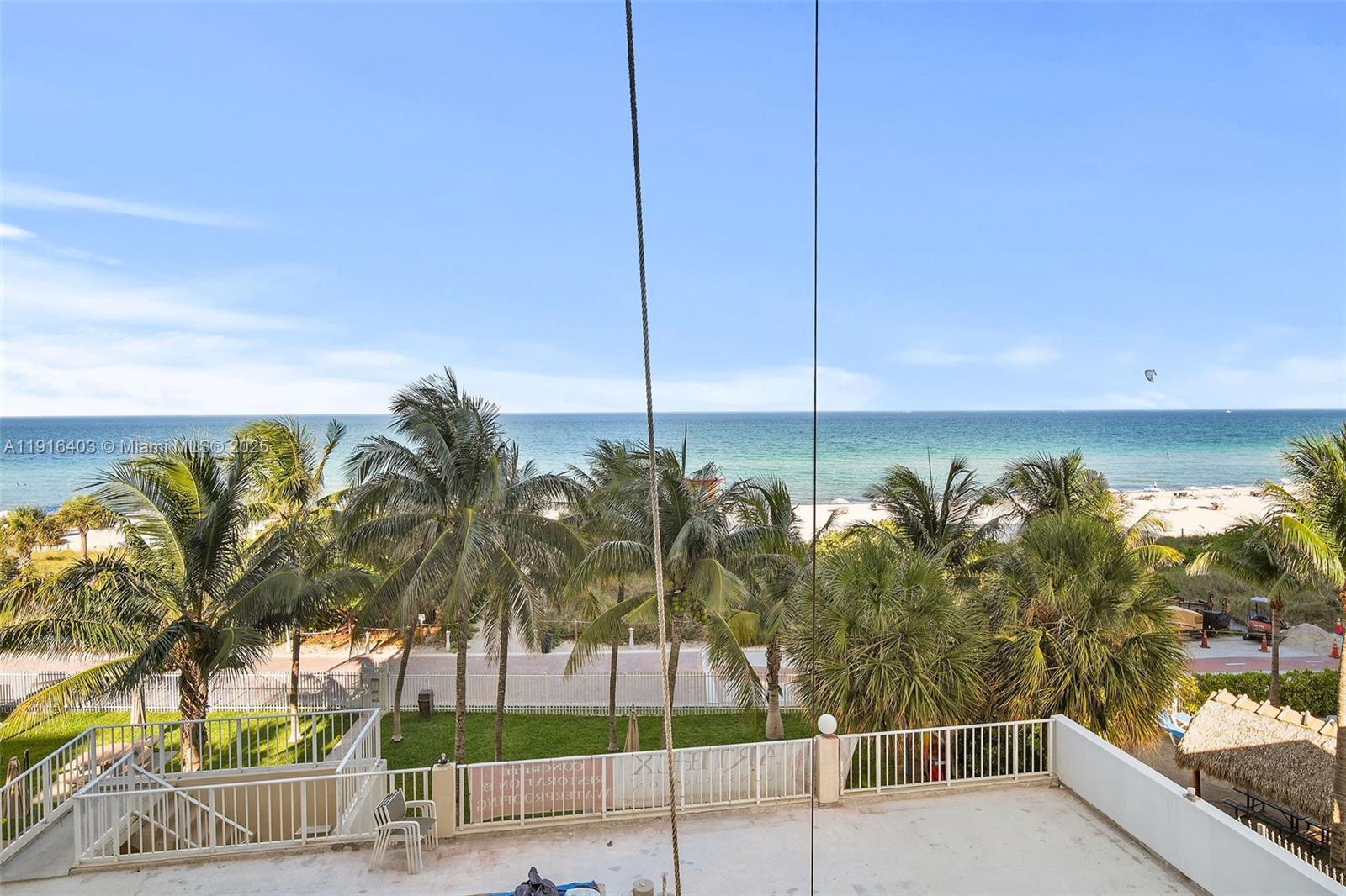 6061 Collins Avenue, Unit 5F Miami Beach, FL 33140 - Photo 22 of 26 a view of a palm tree from a balcony