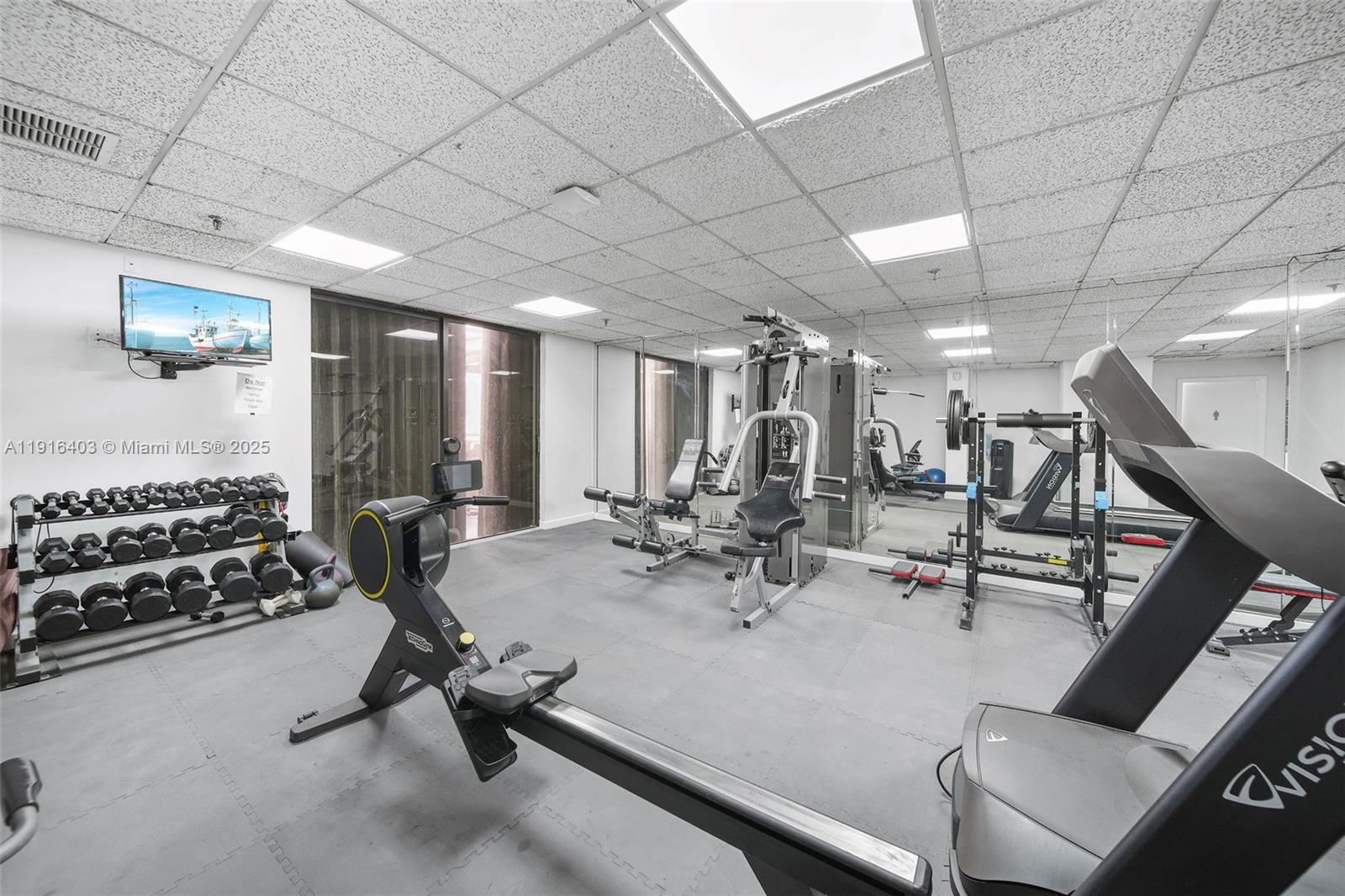 6061 Collins Avenue, Unit 5F Miami Beach, FL 33140 - Photo 24 of 26 a view of a room with gym equipment