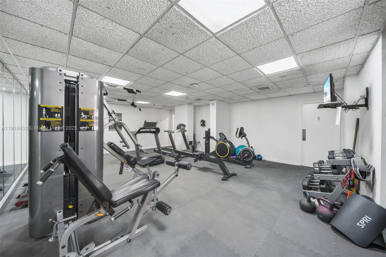6061 Collins Avenue, Unit 5F Miami Beach, FL 33140 - Photo 25 of 26 a view of a room with gym equipment