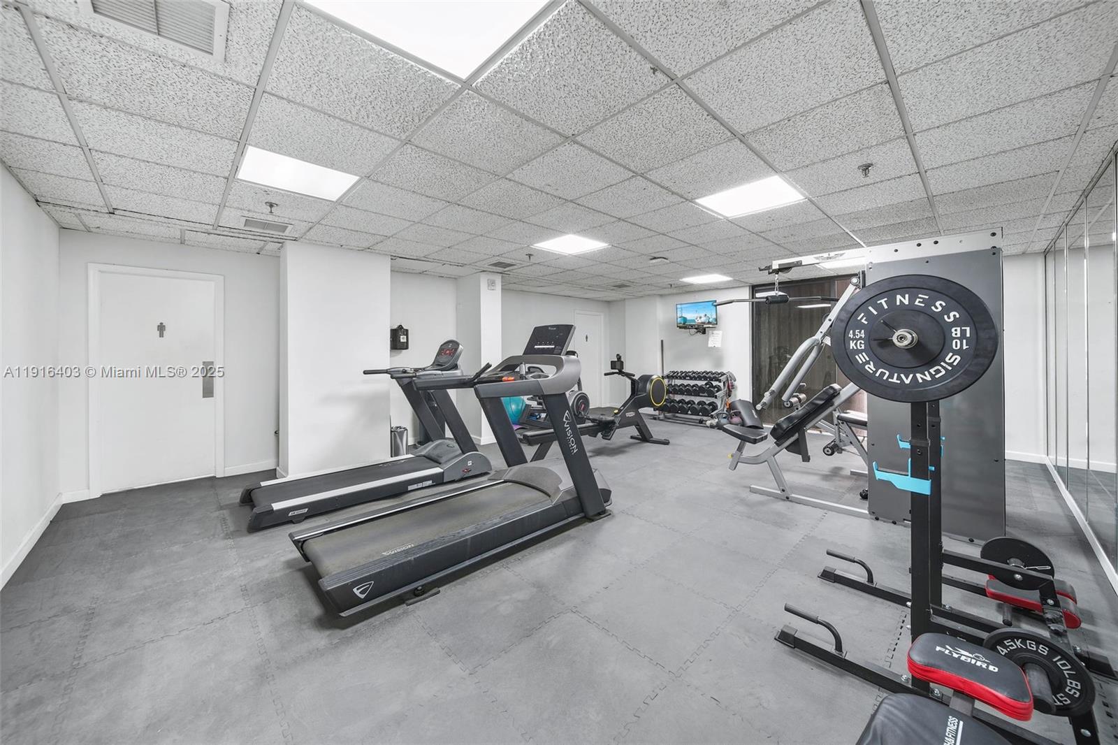 6061 Collins Avenue, Unit 5F Miami Beach, FL 33140 - Photo 26 of 26 a view of a room with gym equipment