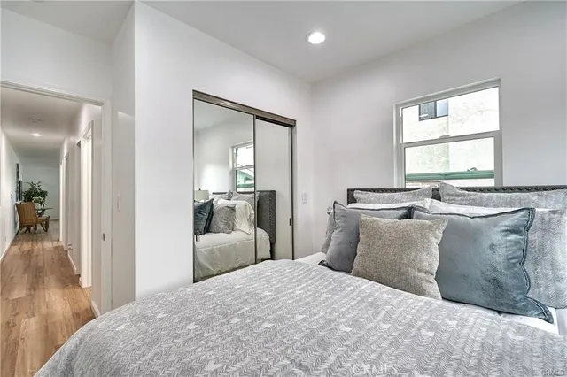 a bedroom with a bed and wooden floor