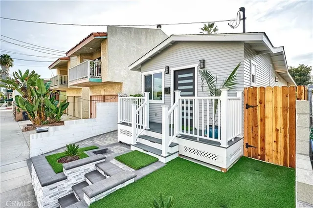 a view of a house with a yard and furniture