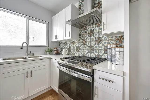 a kitchen with appliances cabinets and a sink