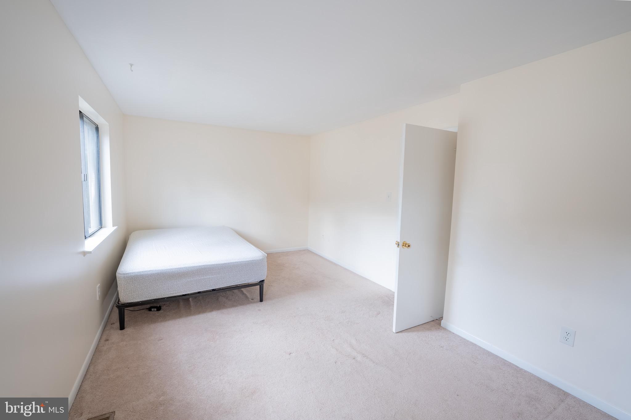 10 Brian Court, Unit 242 Gaithersburg, MD 20877 - Photo 14 of 28 a bedroom with a bed and a window