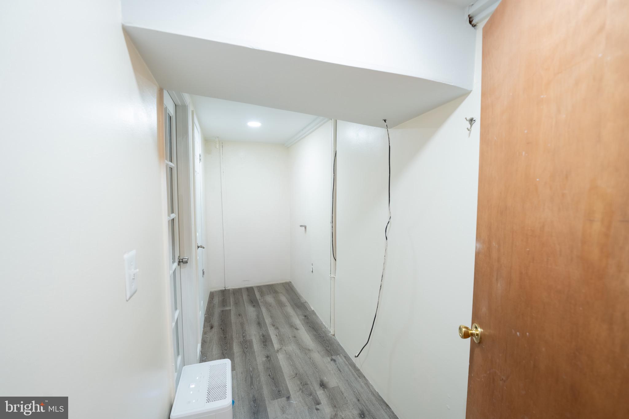 10 Brian Court, Unit 242 Gaithersburg, MD 20877 - Photo 24 of 28 an empty room with wooden floor and a ceiling fan