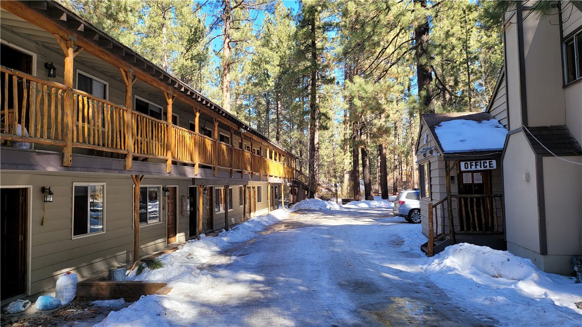 42268 Moonridge Road Big Bear Lake, CA 92315 - Photo 1 of 54 a street view with tall buildings and a yard