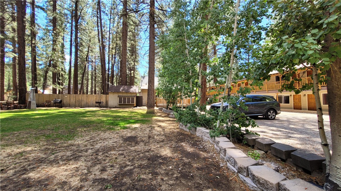 42268 Moonridge Road Big Bear Lake, CA 92315 - Photo 13 of 54 a front view of a house with garden and sitting area