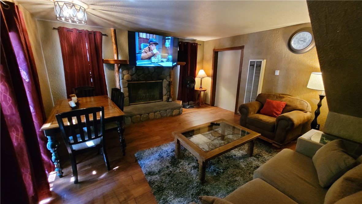 42268 Moonridge Road Big Bear Lake, CA 92315 - Photo 27 of 54 a living room with furniture a flat screen tv and a fireplace