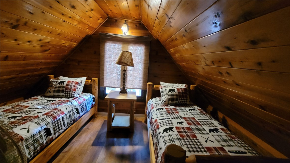 42268 Moonridge Road Big Bear Lake, CA 92315 - Photo 30 of 54 a bed sitting in a bedroom next to a window