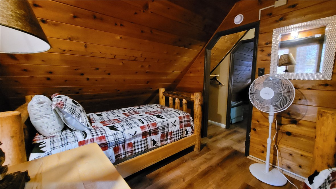 42268 Moonridge Road Big Bear Lake, CA 92315 - Photo 31 of 54 a bed room with a bed and a chandelier