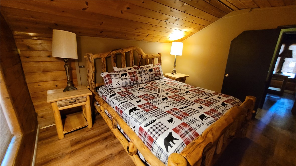 42268 Moonridge Road Big Bear Lake, CA 92315 - Photo 34 of 54 a bed sitting in a bedroom next to a window