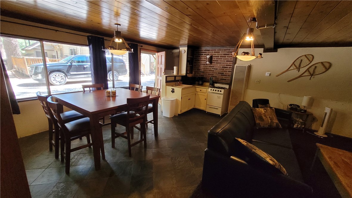 42268 Moonridge Road Big Bear Lake, CA 92315 - Photo 48 of 54 a kitchen with a table chairs and a wooden floor